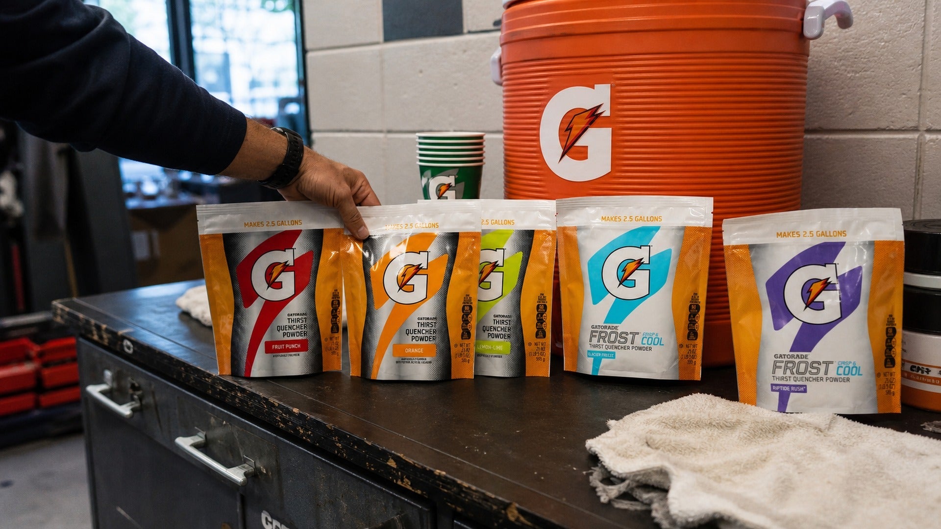 Five Gatorade powder flavours prepared for team practice in an equipment room