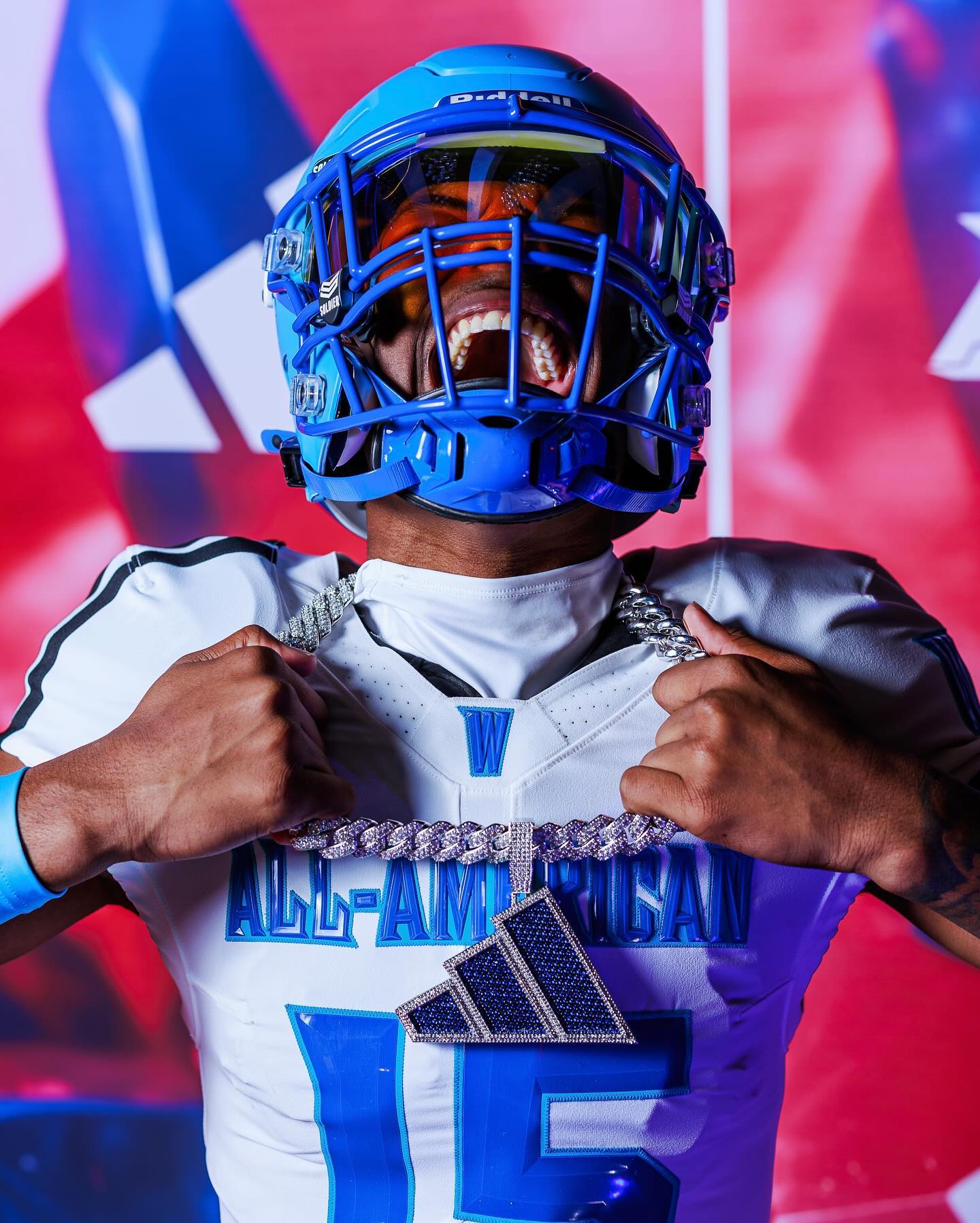 Person wearing a football uniform with 'All-American' and a blue helmet against a colorful background
