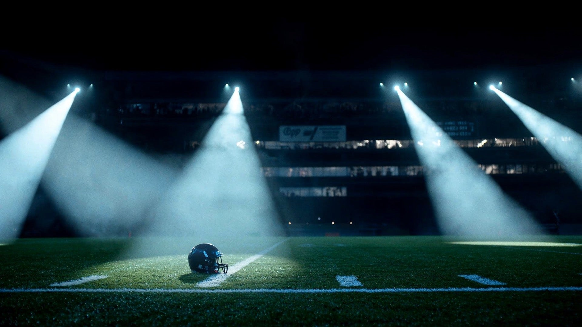 Single football helmet on the yard line under cold blue stadium floodlights, cover for the beginner gear checklist