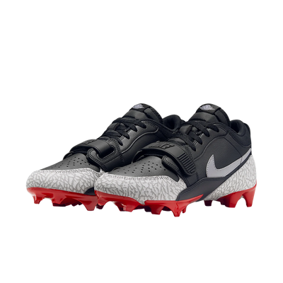 Jordan Legacy 312 Low TD cleat in black and cement grey with red outsole, lateral view